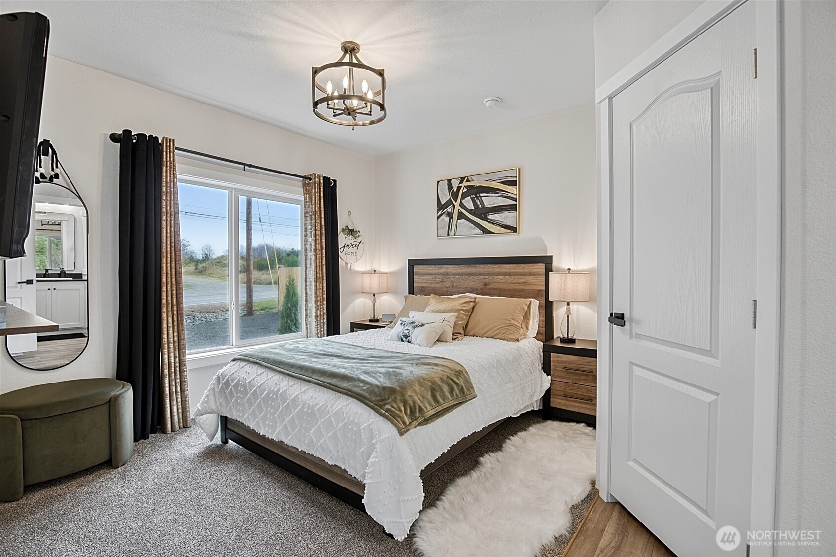 47295 State Route 109 Moclips, WA 98562 - Photo 24 of 40 a bedroom with a large bed and a chandelier