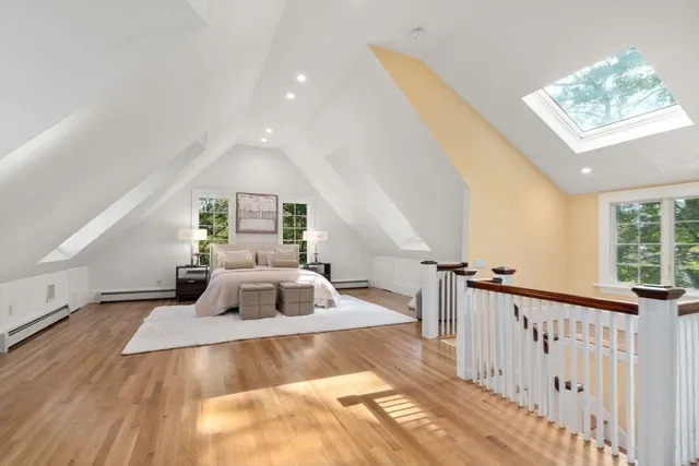 a view of a hallway to a room with wooden floor windows and stairs