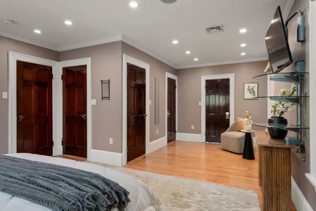 a bedroom with furniture and a wooden floor