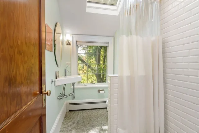a bathroom with a sink a mirror and a shower