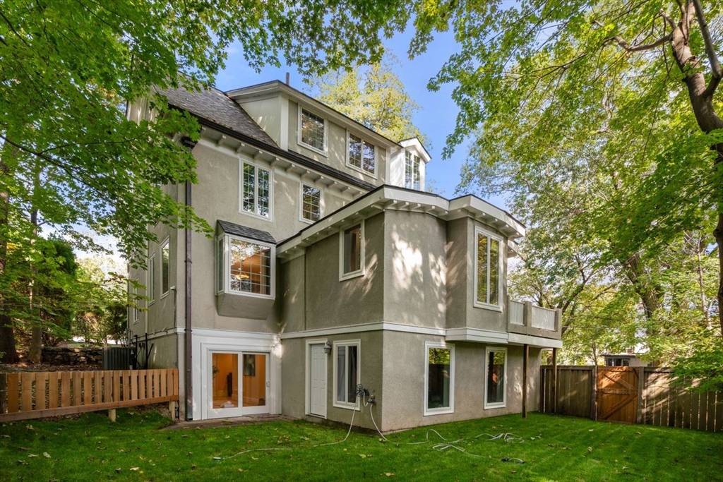 1430 Beacon Street Newton, MA 02468 - Photo 37 of 38 a view of a white house next to a yard with big trees