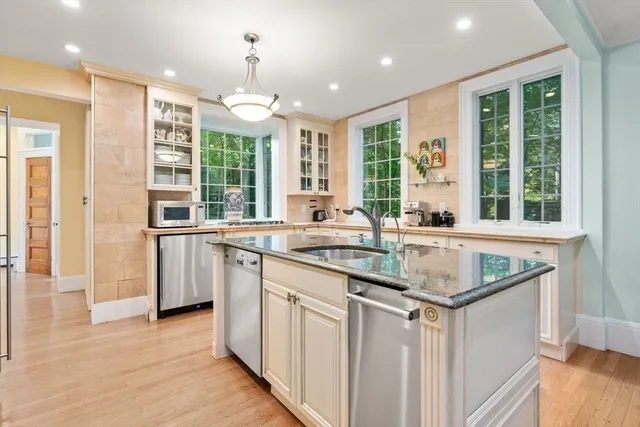 a kitchen with stainless steel appliances granite countertop a stove and a sink