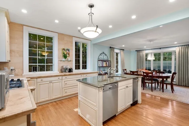 a large kitchen with kitchen island lots of counter space and a dining table