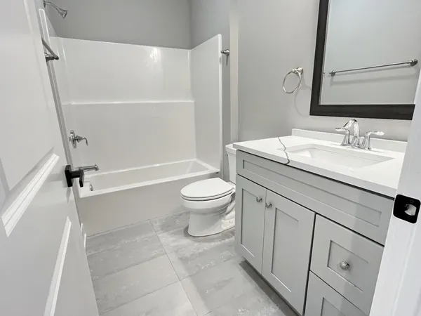 a bathroom with a sink a toilet and a mirror