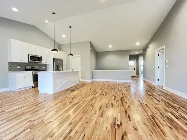 a view of kitchen with cabinets appliances and wooden floor