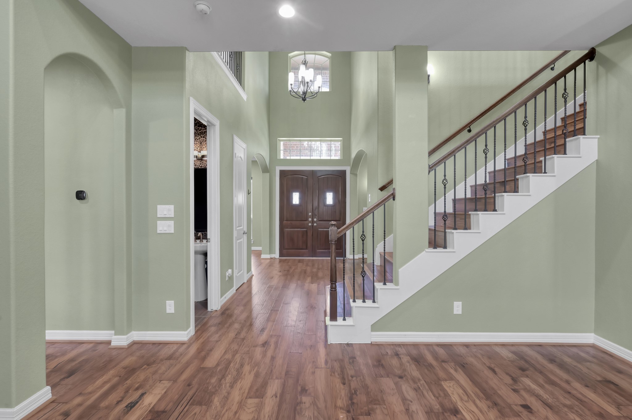 23219 Belted Kingfisher Trail Spring, TX 77389 - Photo 5 of 43 Rich wood flooring and high ceilings bring warmth and sophistication to the entrance.