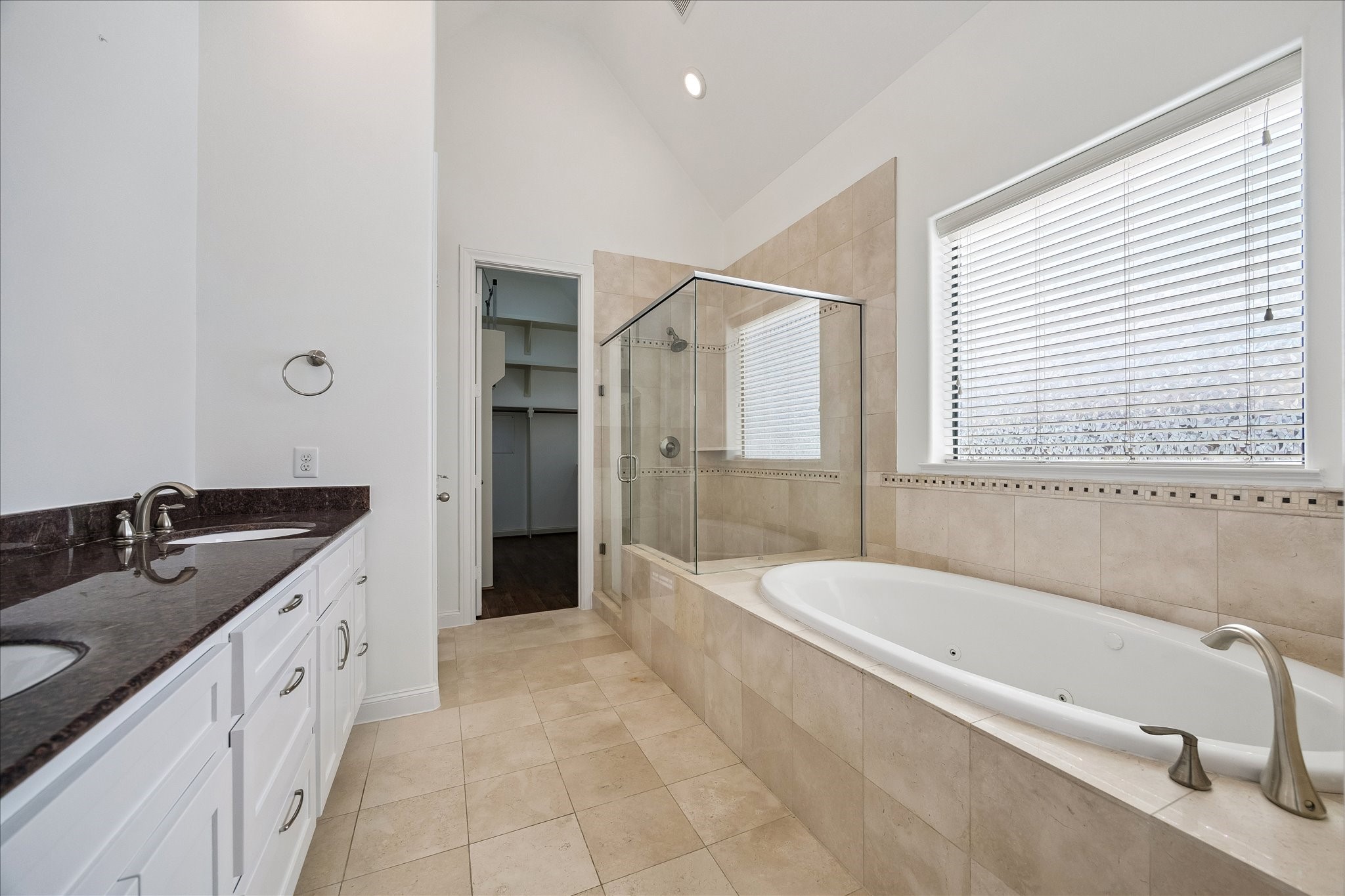 1407 Shearn Street Houston, TX 77007 - Photo 27 of 35 Primary bathroom elegantly outfitted with granite counters and natural stone tiles.