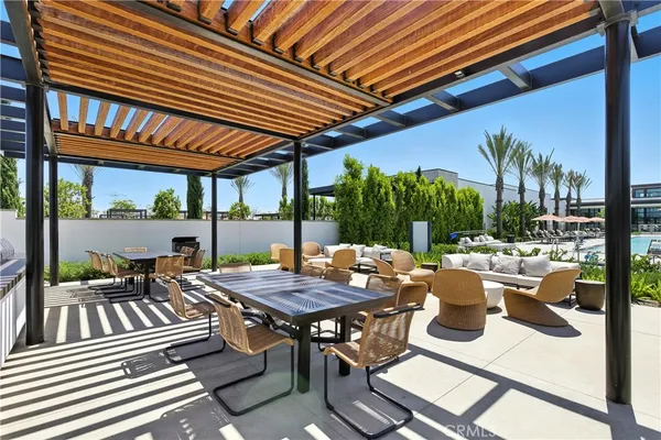 a view of a patio with table and chairs and potted plants