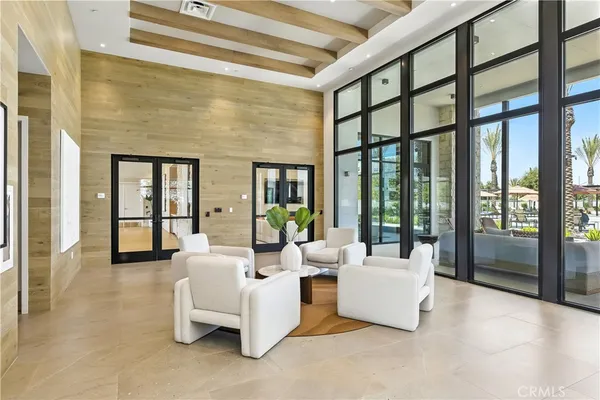 a living room with furniture and large windows