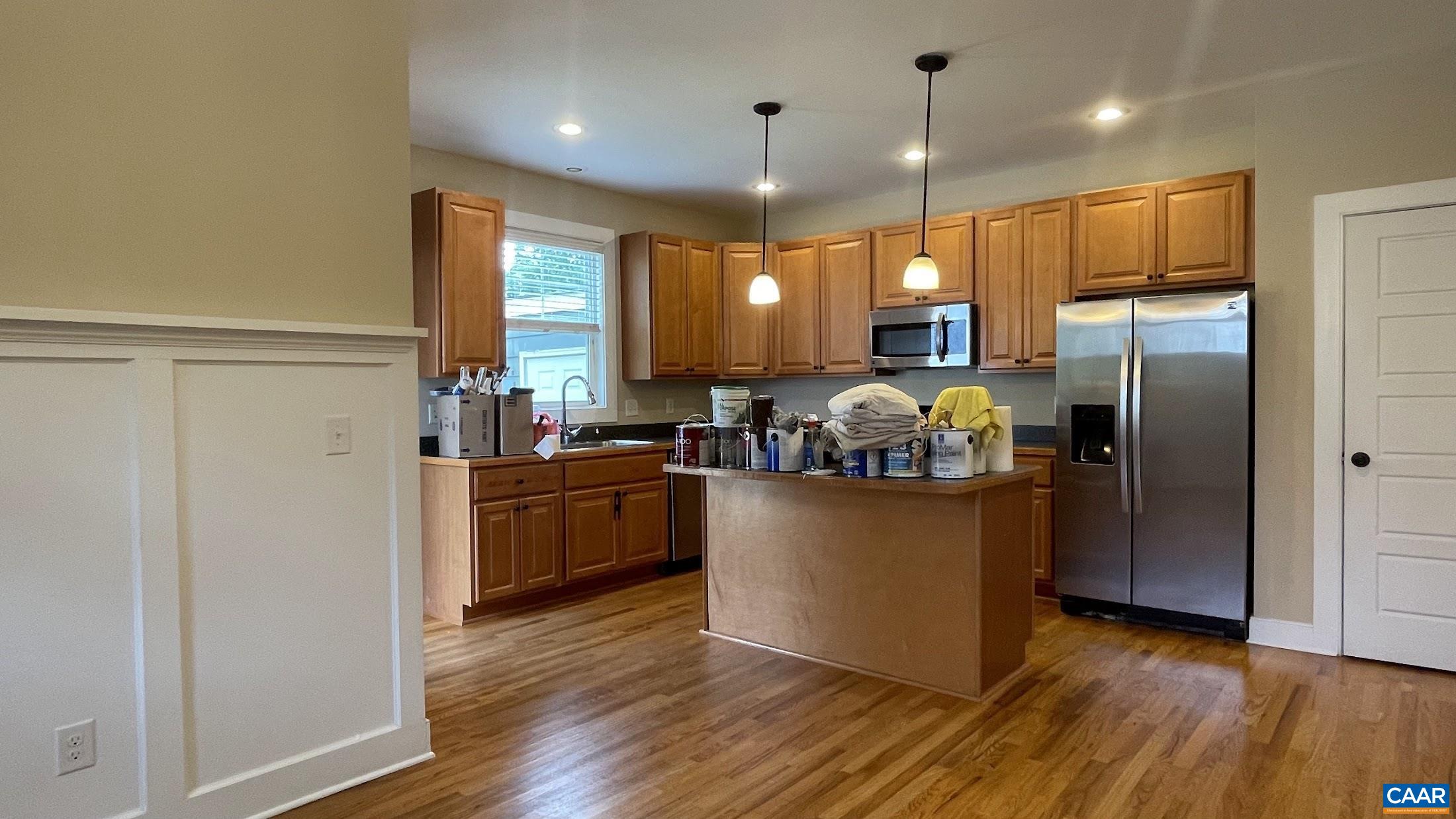 200 Harris Road Charlottesville, VA 22903 - Photo 11 of 28 a kitchen with stainless steel appliances granite countertop a refrigerator a sink dishwasher a oven and a dining table with wooden floor