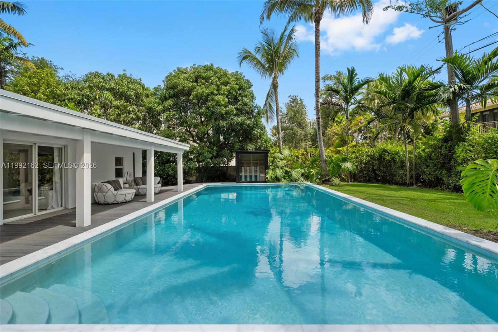 7531 Southwest 52nd Court Miami, FL 33143 - Photo 1 of 56 a swimming pool with outdoor seating and yard