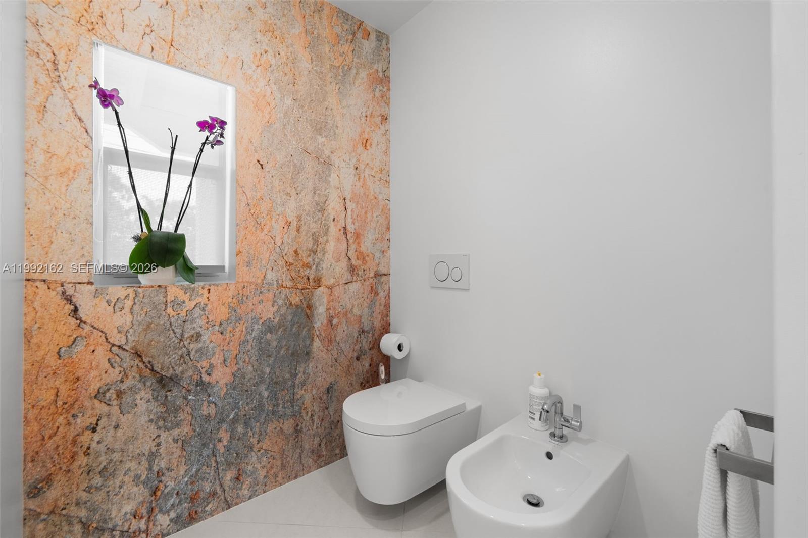 7531 Southwest 52nd Court Miami, FL 33143 - Photo 23 of 56 a bathroom with a sink and mirror with toilet