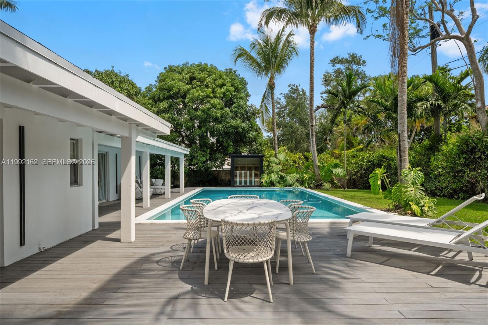 7531 Southwest 52nd Court Miami, FL 33143 - Photo 3 of 56 a view of a patio with table and chairs potted plants and palm tree