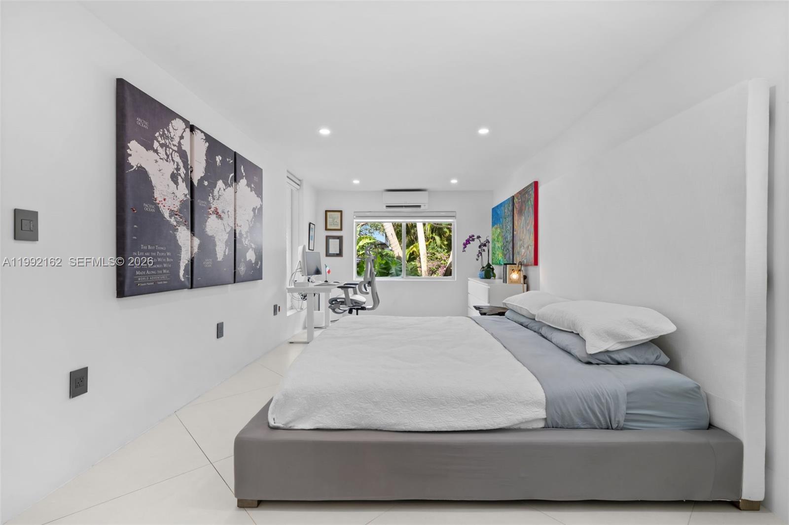 7531 Southwest 52nd Court Miami, FL 33143 - Photo 34 of 56 a spacious bedroom with a bed and a painting on the wall
