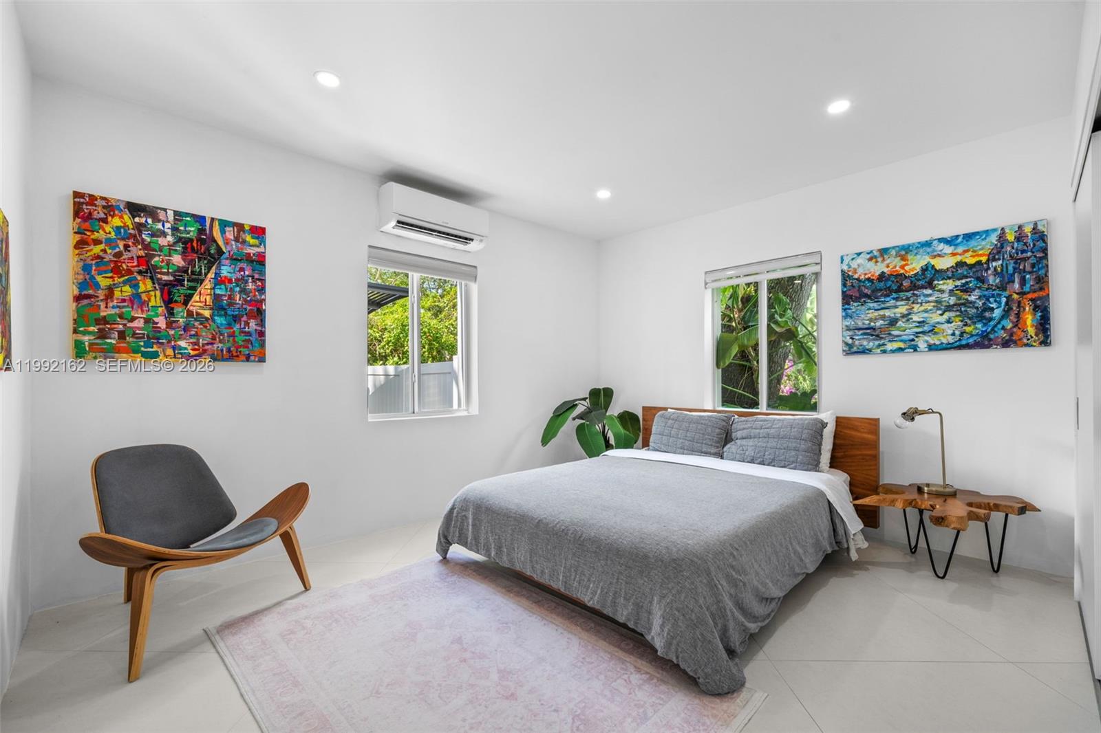 7531 Southwest 52nd Court Miami, FL 33143 - Photo 37 of 56 a bedroom with a bed a painting on the wall and a large window