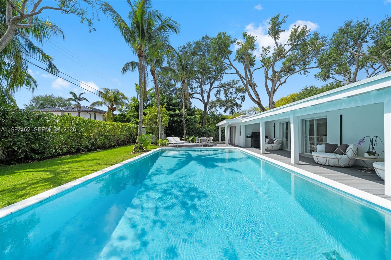 7531 Southwest 52nd Court Miami, FL 33143 - Photo 44 of 56 a view of a house with swimming pool and a yard