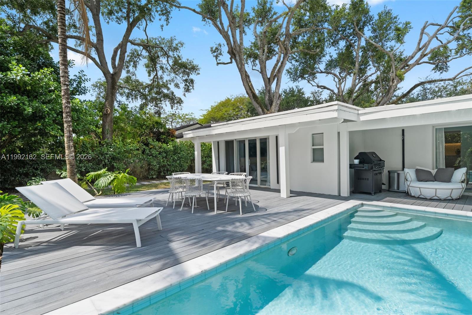 7531 Southwest 52nd Court Miami, FL 33143 - Photo 5 of 56 a view of a house with backyard sitting area and garden