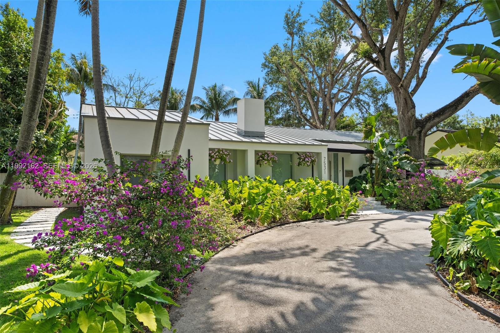 7531 Southwest 52nd Court Miami, FL 33143 - Photo 7 of 56 a front view of a house with a garden