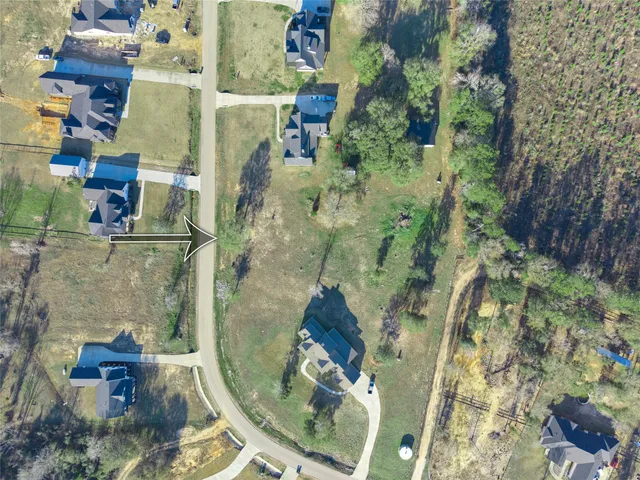 an aerial view of a house with a lake view