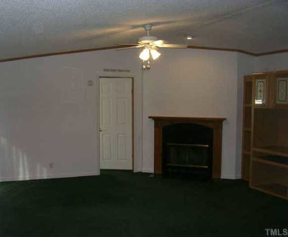 1707 Cedar Grove Church Road Roxboro, NC 27574 - Photo 3 of 9 Living area with fireplace and entertainment center