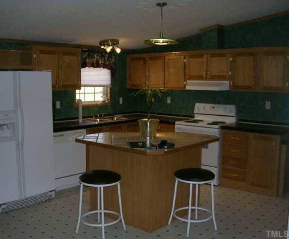 1707 Cedar Grove Church Road Roxboro, NC 27574 - Photo 5 of 9 Kitchen offers center island with ceramic tile top and pantry