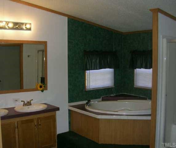 1707 Cedar Grove Church Road Roxboro, NC 27574 - Photo 6 of 9 Master bath offers garden tub and separate shower.