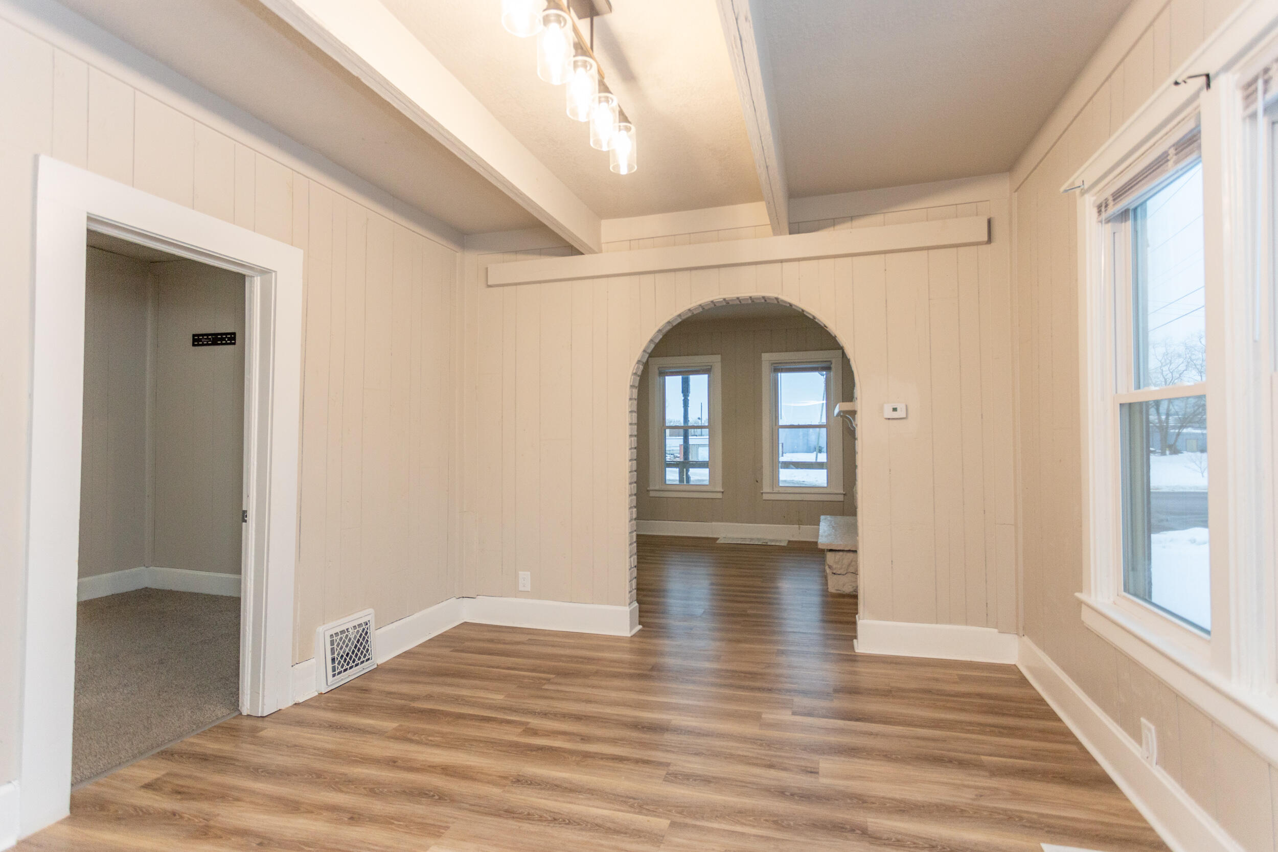 1602 Kentucky Street, Unit 1 Michigan City, IN 46360 - Photo 4 of 13 a view of empty room with window and wooden floor
