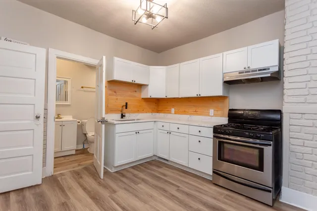 a kitchen with a stove oven and sink