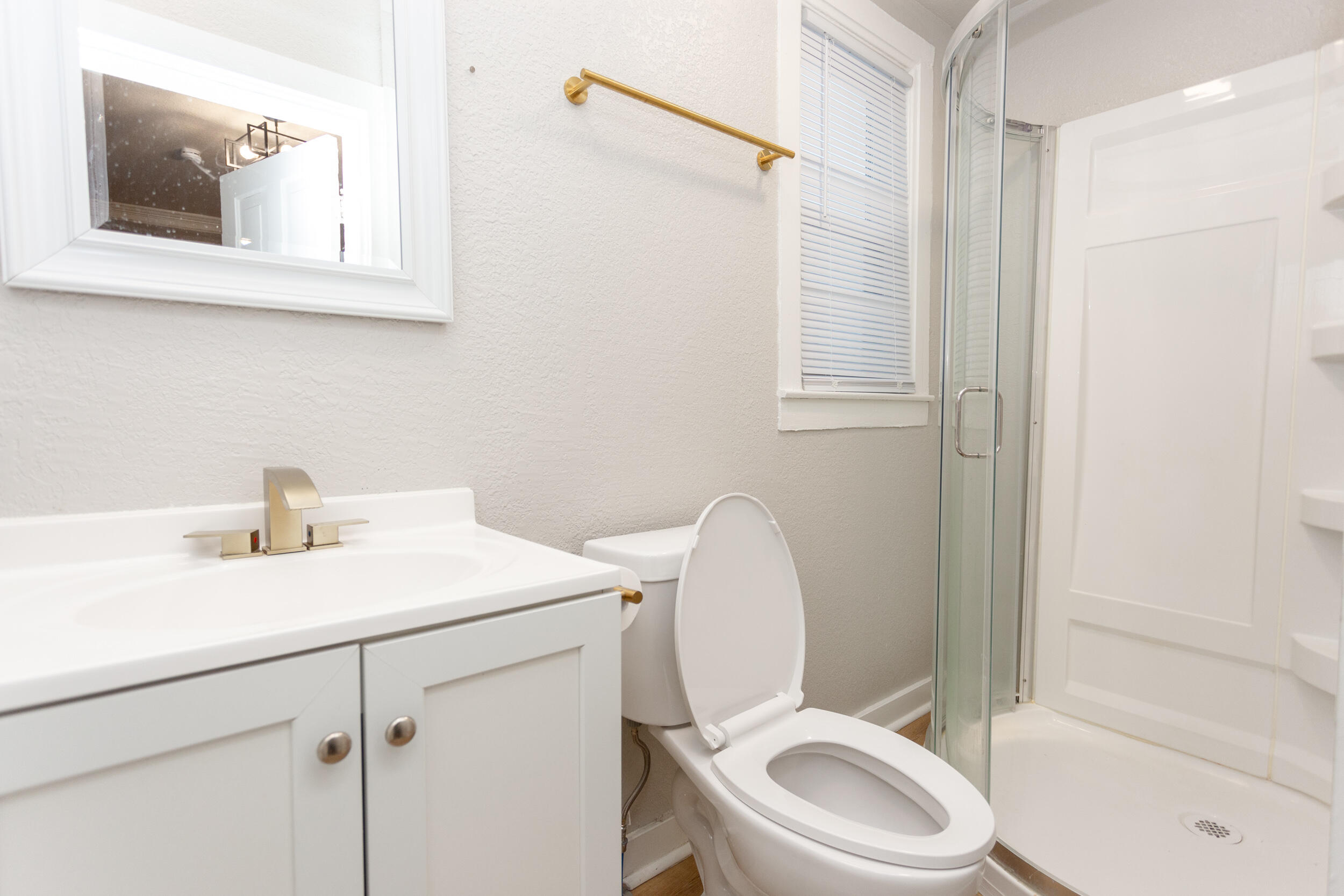 1602 Kentucky Street, Unit 1 Michigan City, IN 46360 - Photo 8 of 13 a bathroom with a toilet sink vanity and mirror