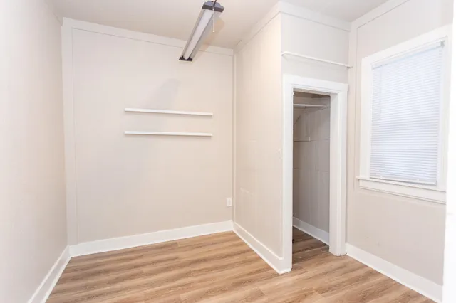 a view of a room with wooden floor