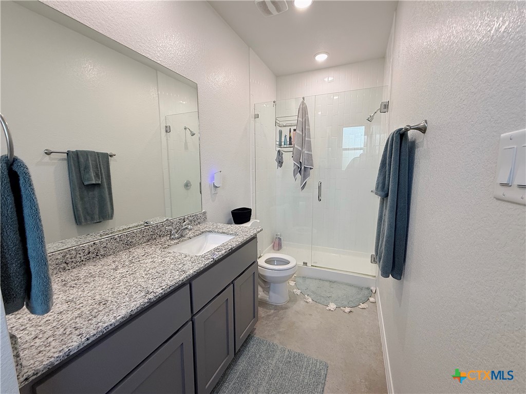 211 Riptide Road Temple, TX 76501 - Photo 8 of 11 a bathroom with a granite countertop sink toilet and shower