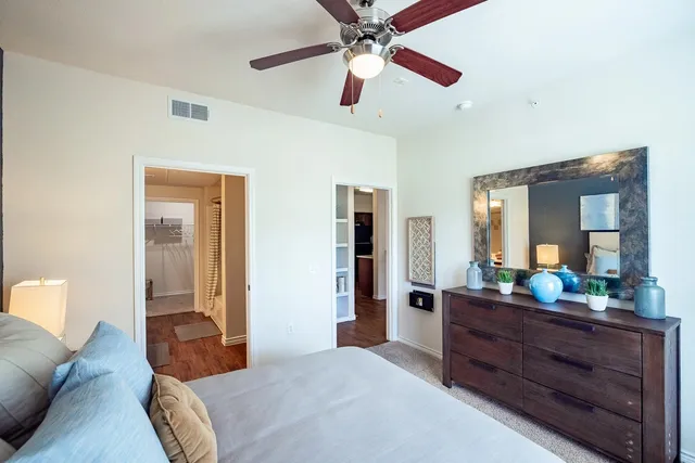 a bedroom with a bed and a chandelier