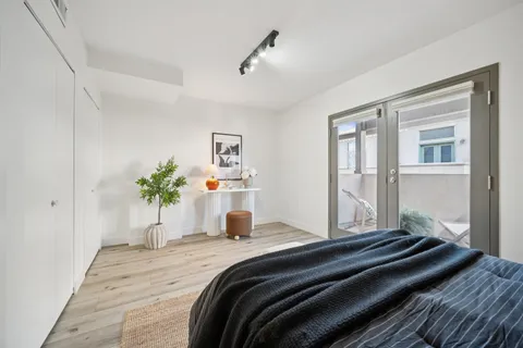 a bedroom with a bed and a chandelier