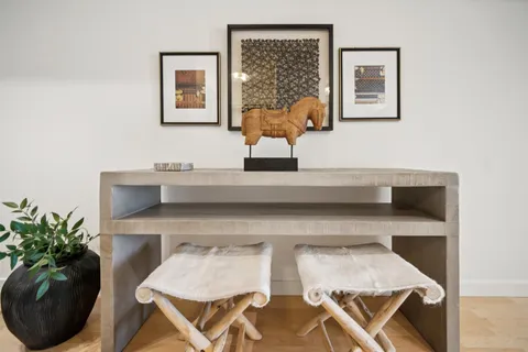 a living room with furniture and flowers