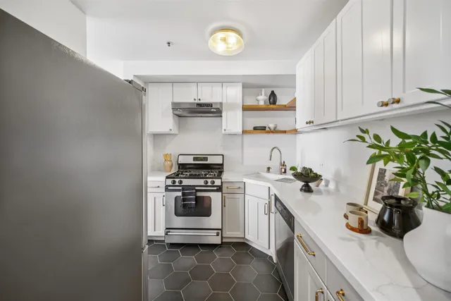 a kitchen with a sink a stove and cabinets