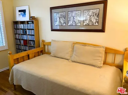 a bedroom with a bed and a desk