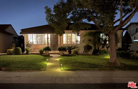 a view of a house with swimming pool and sitting area