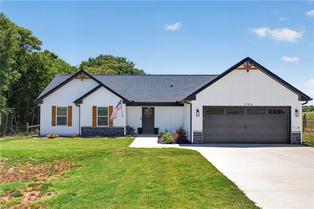 106 Bolt Road Townville, SC 29689 - Photo 1 of 33 A welcoming facade showcases a well-maintained driveway leading to a modern garage.