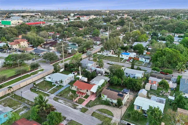 a bedroom with a bed and a mirror on the dresser