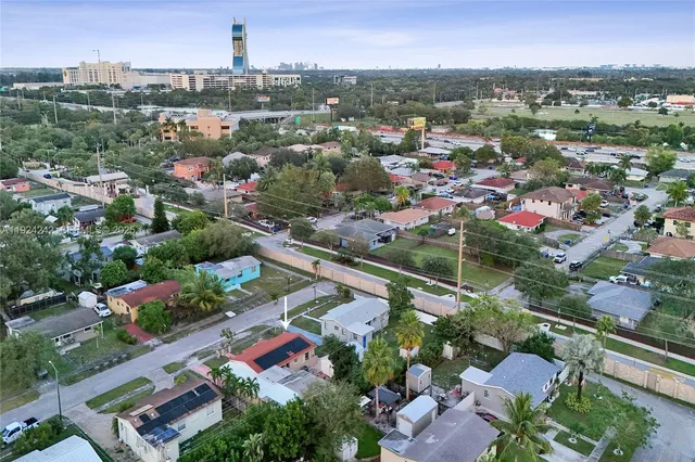 a kitchen with stainless steel appliances granite countertop a sink and a refrigerator