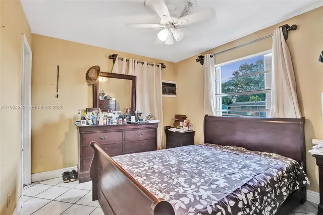 a bedroom with a white bed and a chandelier