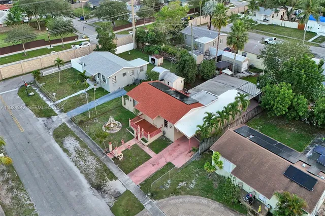 an aerial view of residential houses with outdoor space