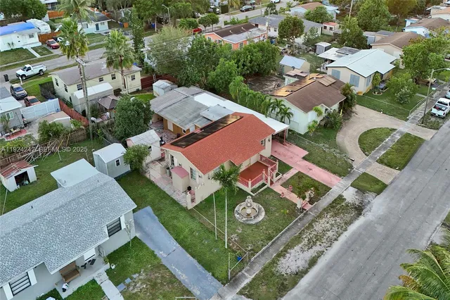 an aerial view of residential houses with city view
