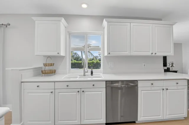 a kitchen with white cabinets and a sink