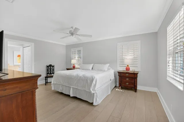 a spacious bedroom with a bed and a chandelier