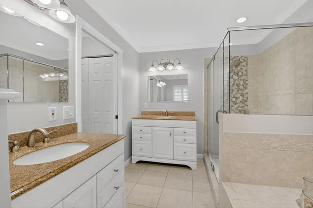a spacious bathroom with a granite countertop sink mirror and a