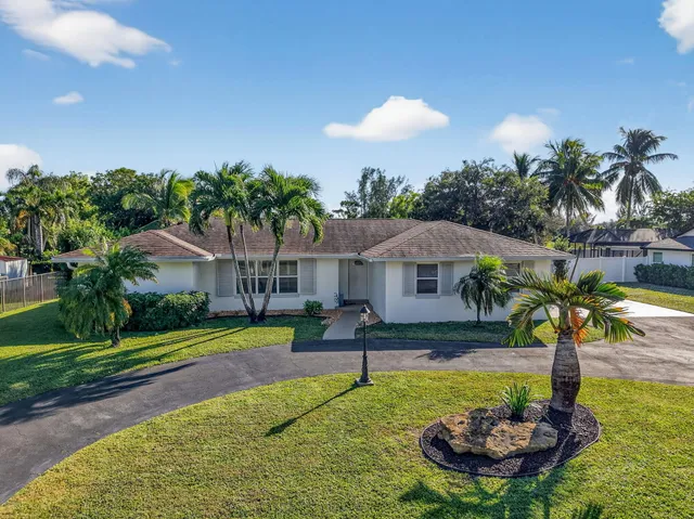 a swimming pool with lots of tress in front of it