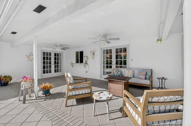 a living room with furniture and flowers