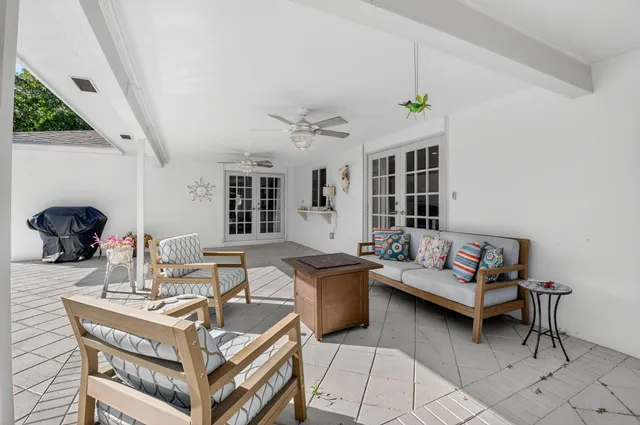 a living room with furniture a rug and a chandelier
