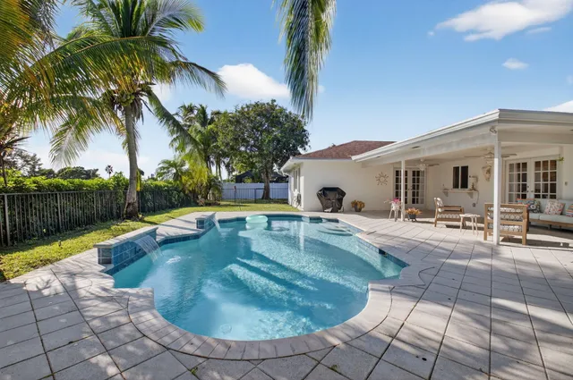 a view of a house with swimming pool and sitting area